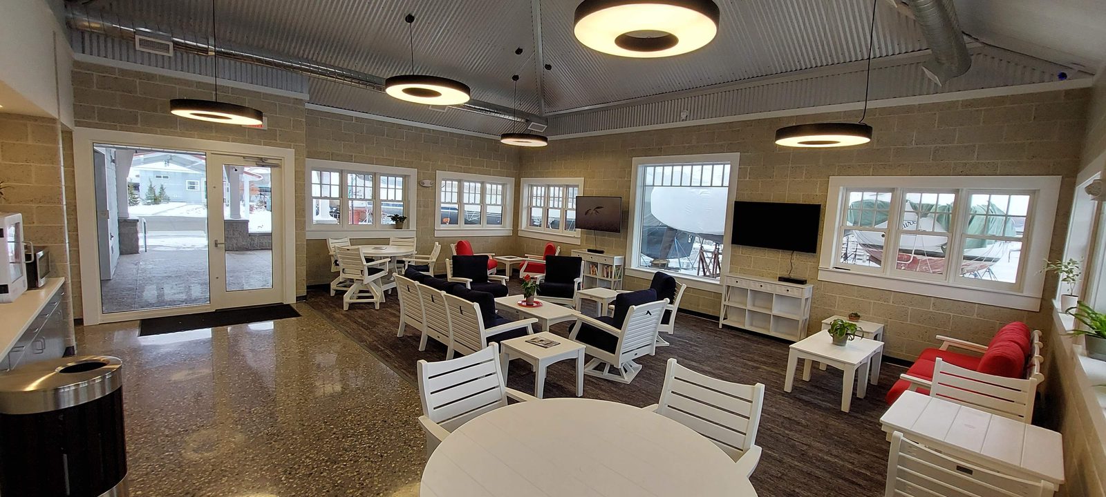 Panoramic view of the Captain's Lounge seating beneath a vaulted metal ceiling.