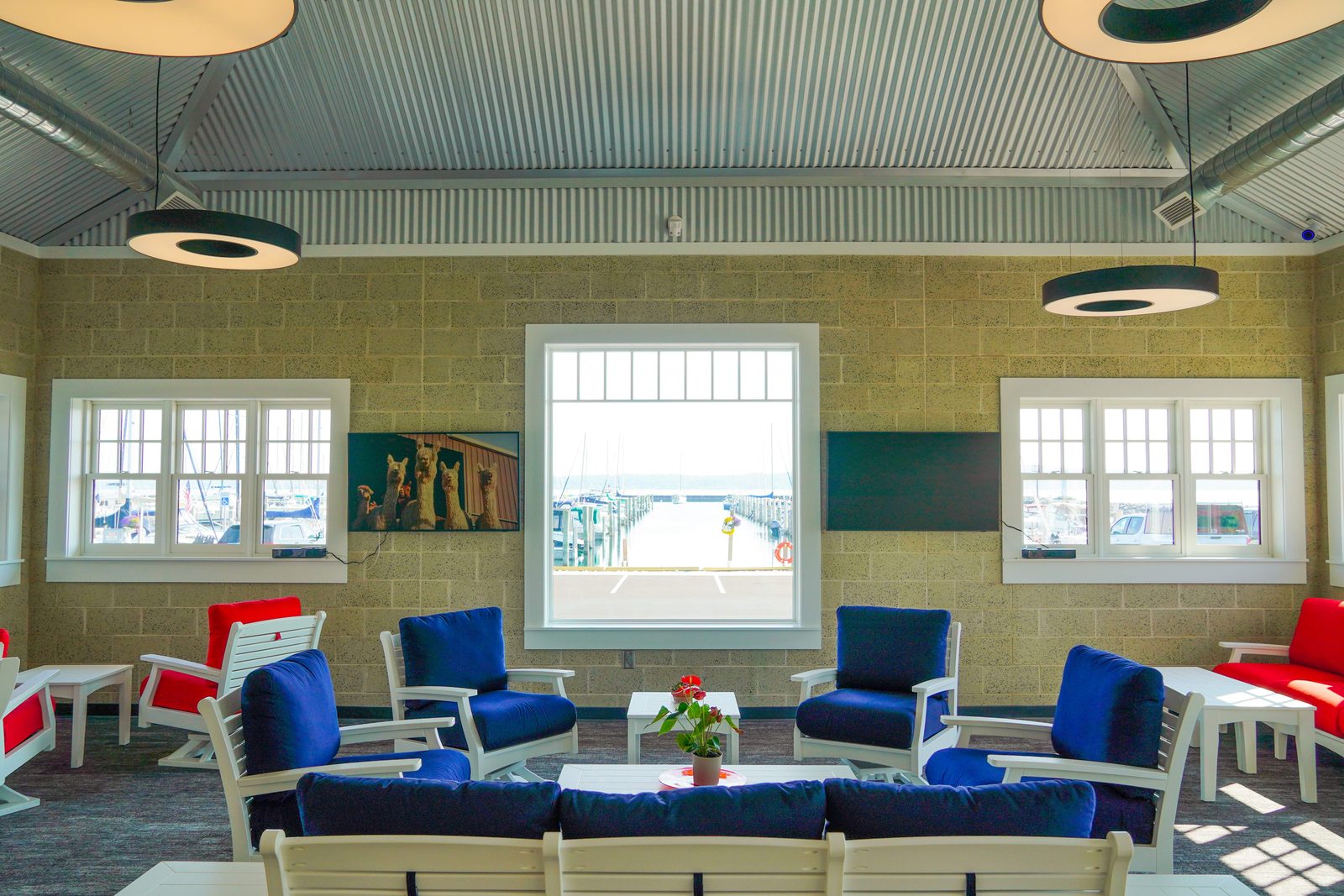 Wide view of the Captain's Lounge with lounge groupings and glass doors to the patio.