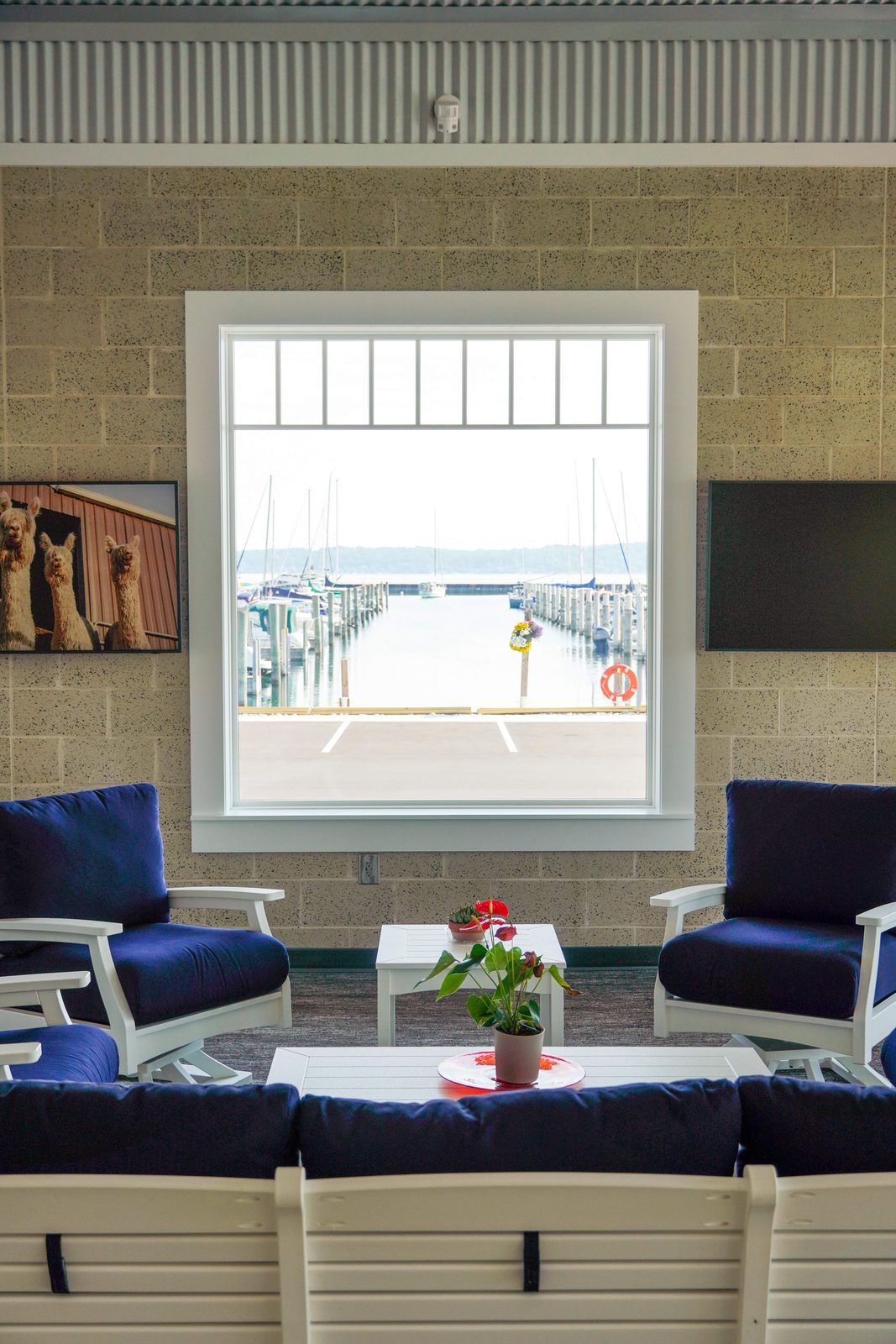 Coffee and microwave counter below a copper compass-rose clock in the Captain's Lounge.