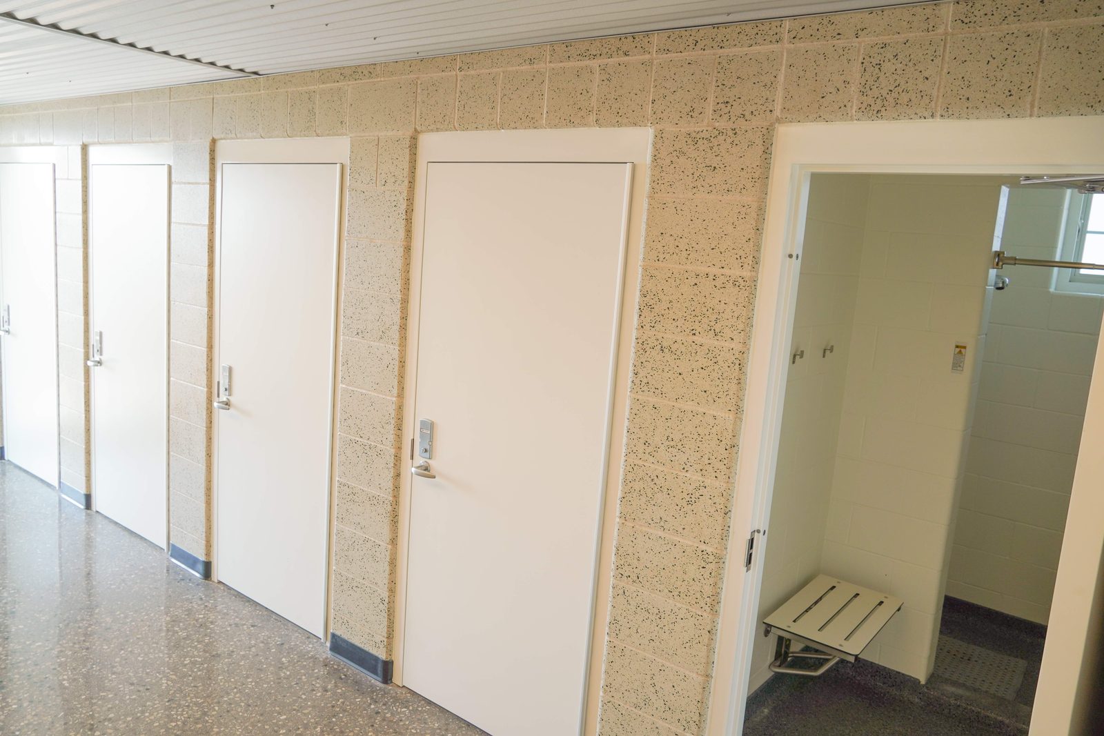 Boaters' bathhouse hallway with private restrooms and accessible showers.