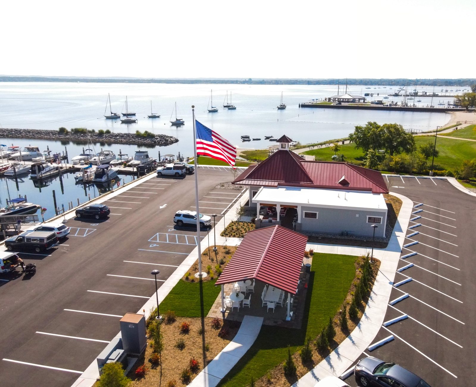 Covered patio with red and navy lounge seating and a decorative ship's anchor.