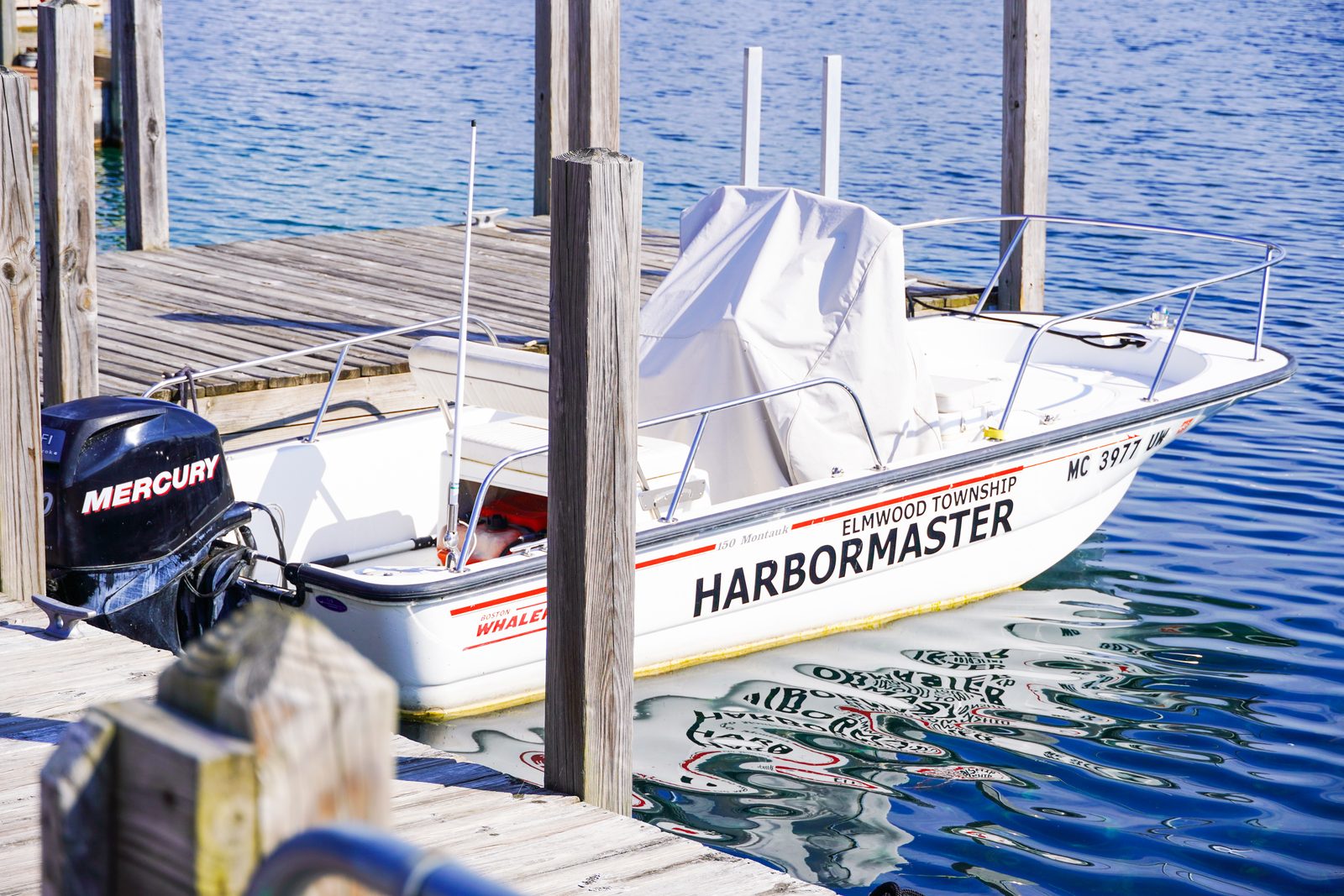 The Elmwood Township harbormaster's Boston Whaler tied up at the dock on a sunny day.