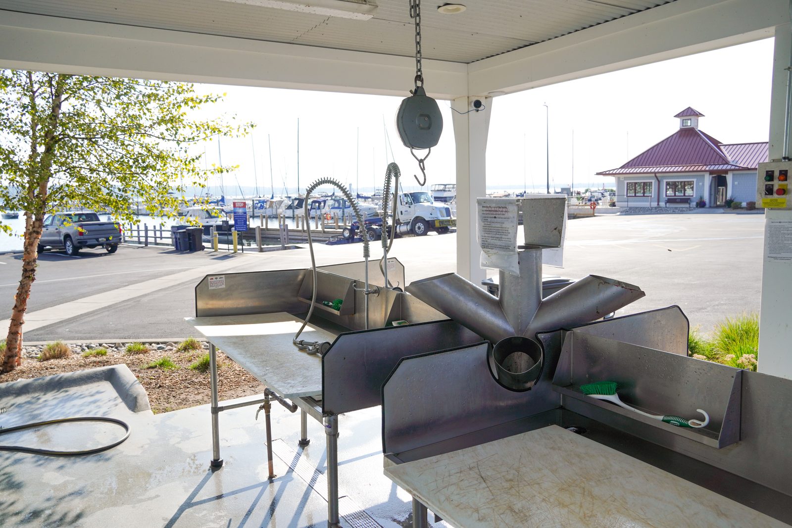 Fish-cleaning tables and grinder with the marina office in the background.