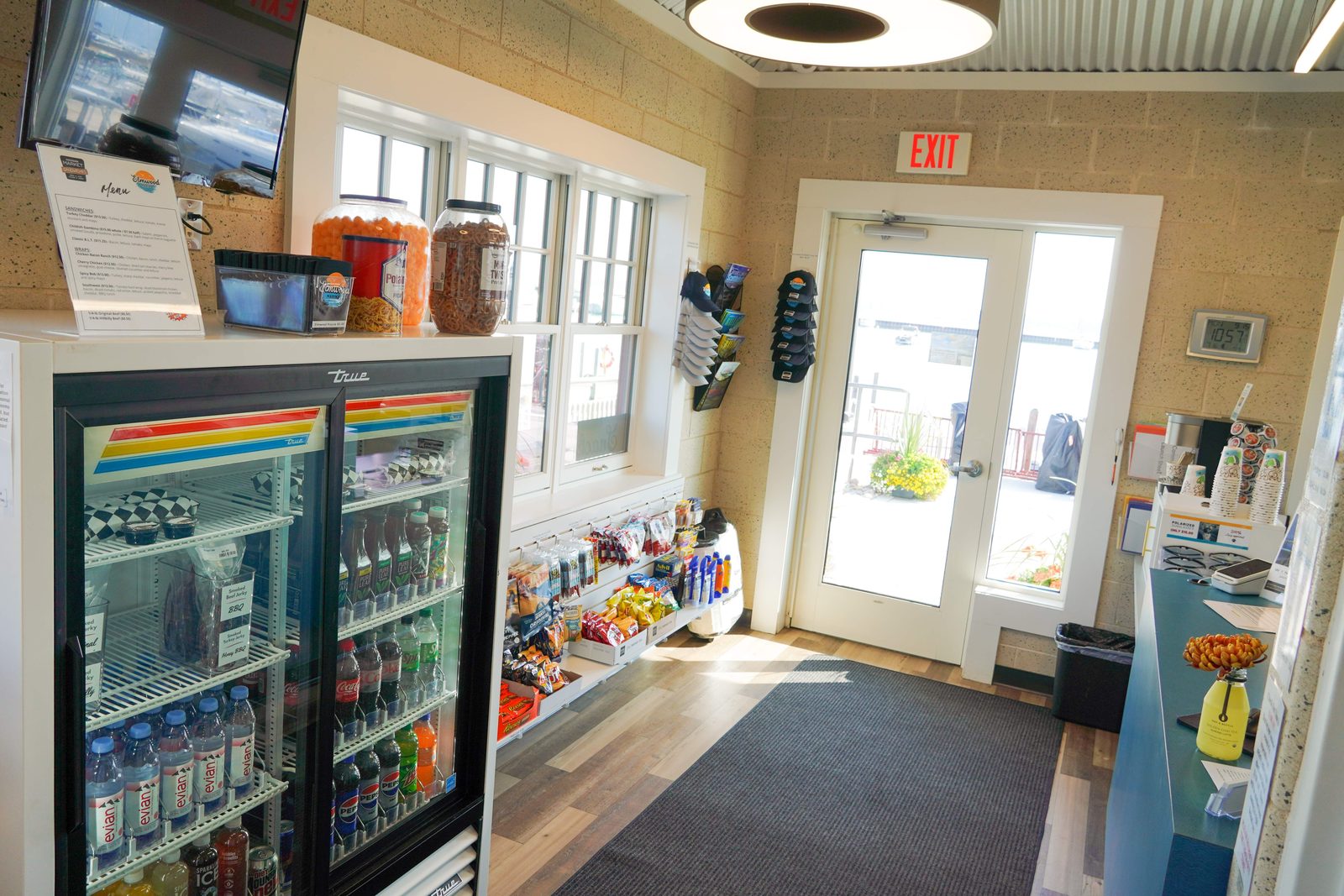 The marina store interior with snacks, drinks, marine supplies, and apparel along the aisle.
