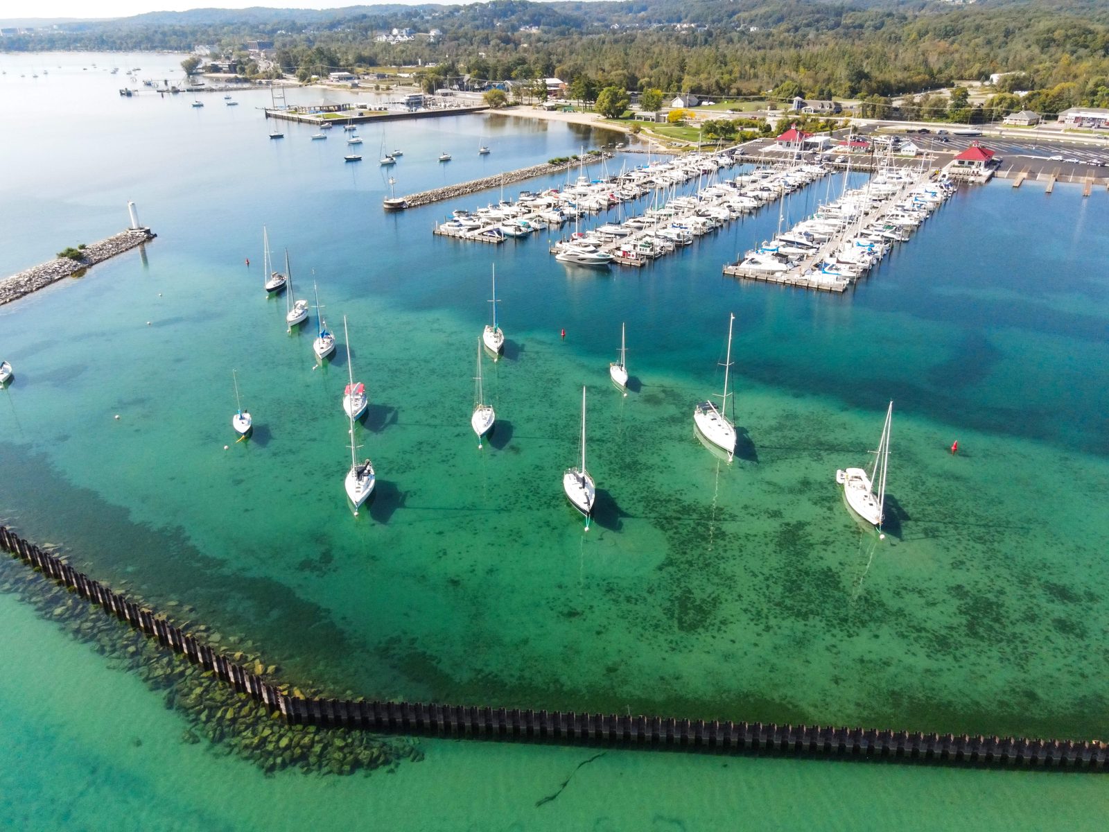 Aerial of the mooring field and marina basin in clear turquoise water.